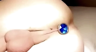 Twink with grasping balls puts butt plug in grasping opening