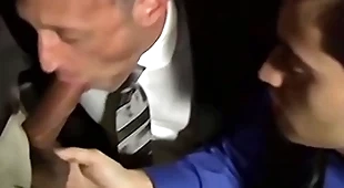 Bald bearded stud sucking several cocks in an orgy
